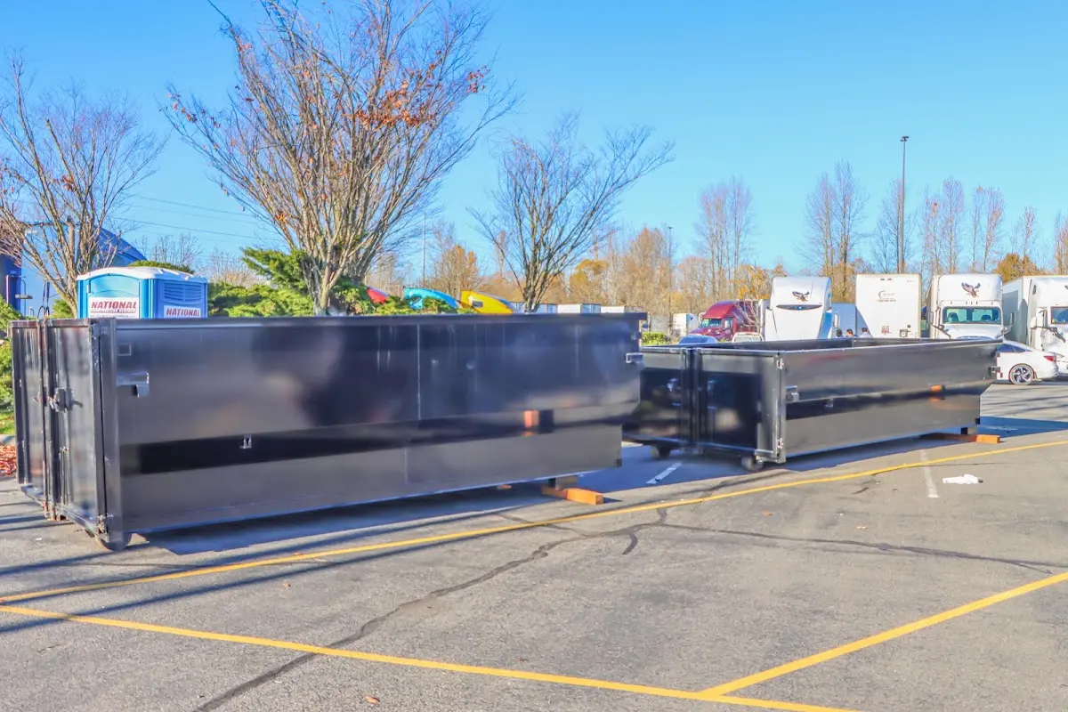 Professional dumpster rental service with roll-off container on residential driveway in Mount Pleasant